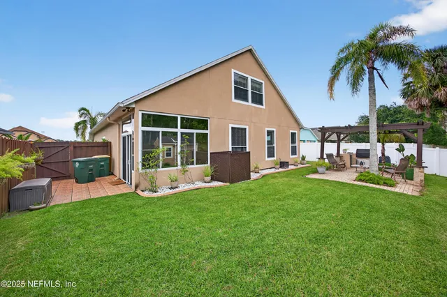 a view of a house with a backyard and a patio