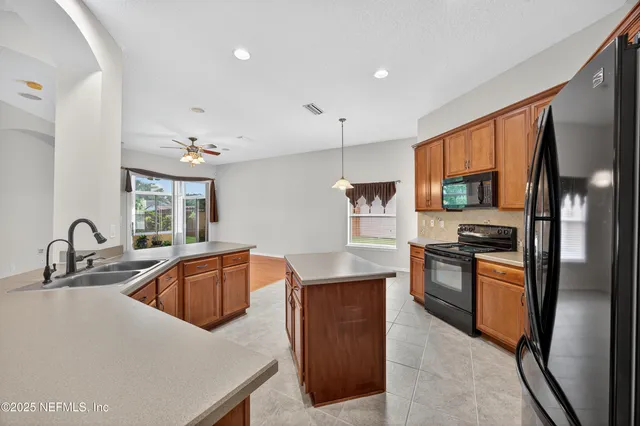 a kitchen with granite countertop a sink and appliances
