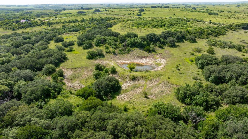 501 County Road 103, Unit 1 Comanche, TX 76442 - Photo 22 of 38 an aerial view of residential houses with outdoor space and trees