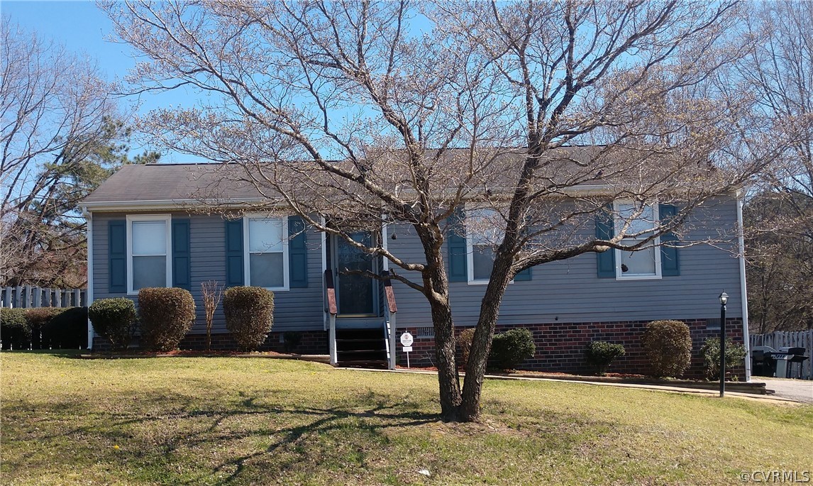 a view of a house with a yard covered in snow