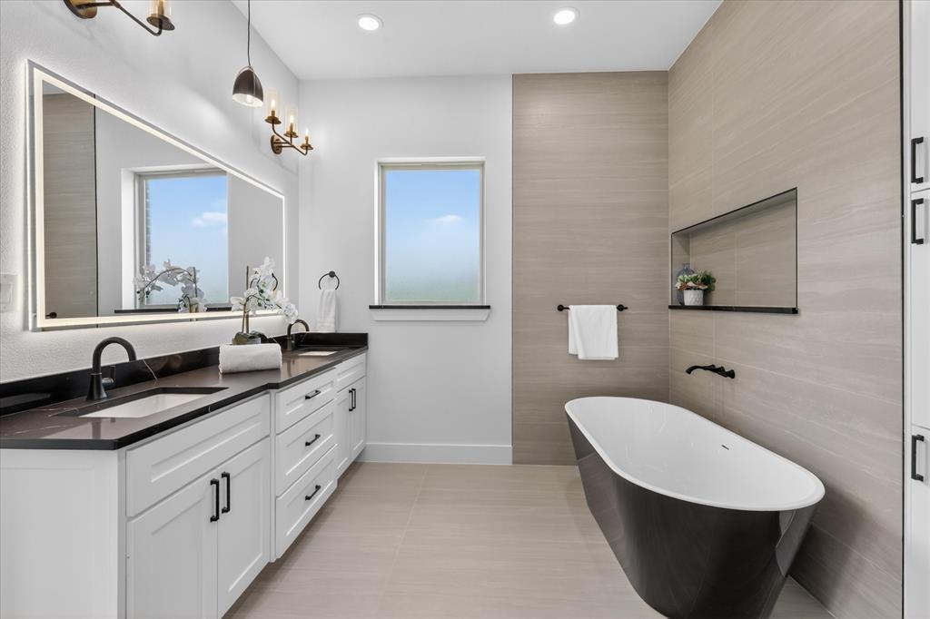 182 Briar Patch Azle, TX 76020 - Photo 21 of 36 Full bathroom with double vanity, tile walls, a freestanding tub, recessed lighting, and light tile patterned floors