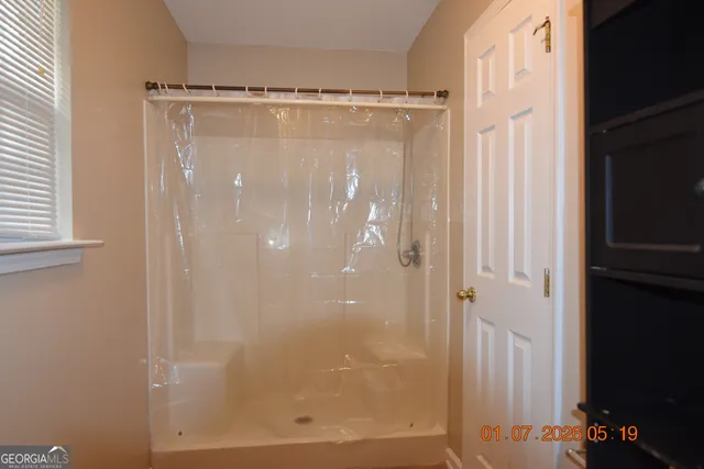 a bathroom with a glass shower door