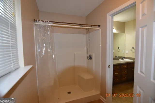 a bathroom with a glass shower door