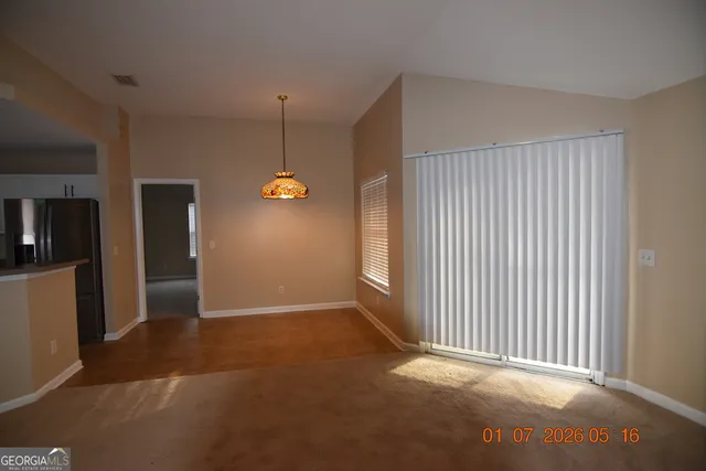 an empty room with windows and entrance