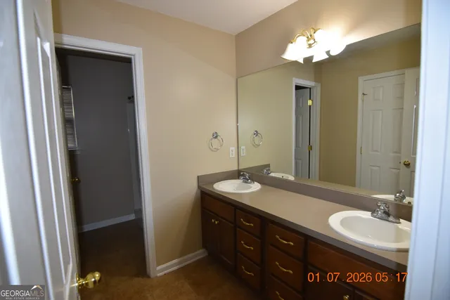 a bathroom with a double vanity sink and a mirror