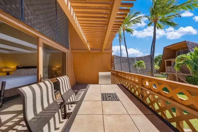 a balcony with furniture and potted plants