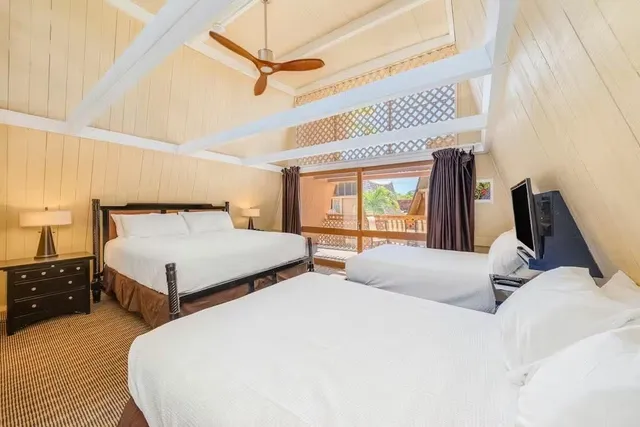 a bedroom with bed and a large window