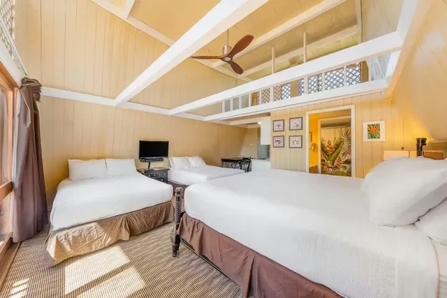 a spacious bedroom with a bed a couch and dresser