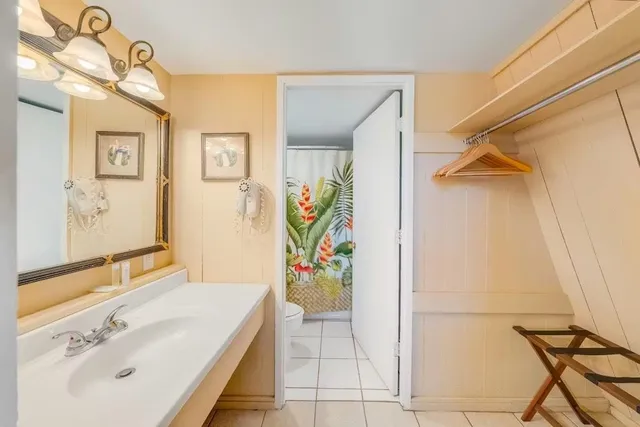 a bathroom with a tub sink and mirror
