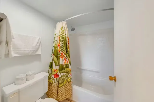 a view of a bathtub & sink in a bathroom