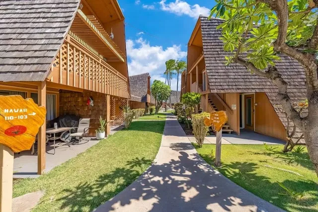 a front view of a house with garden and patio