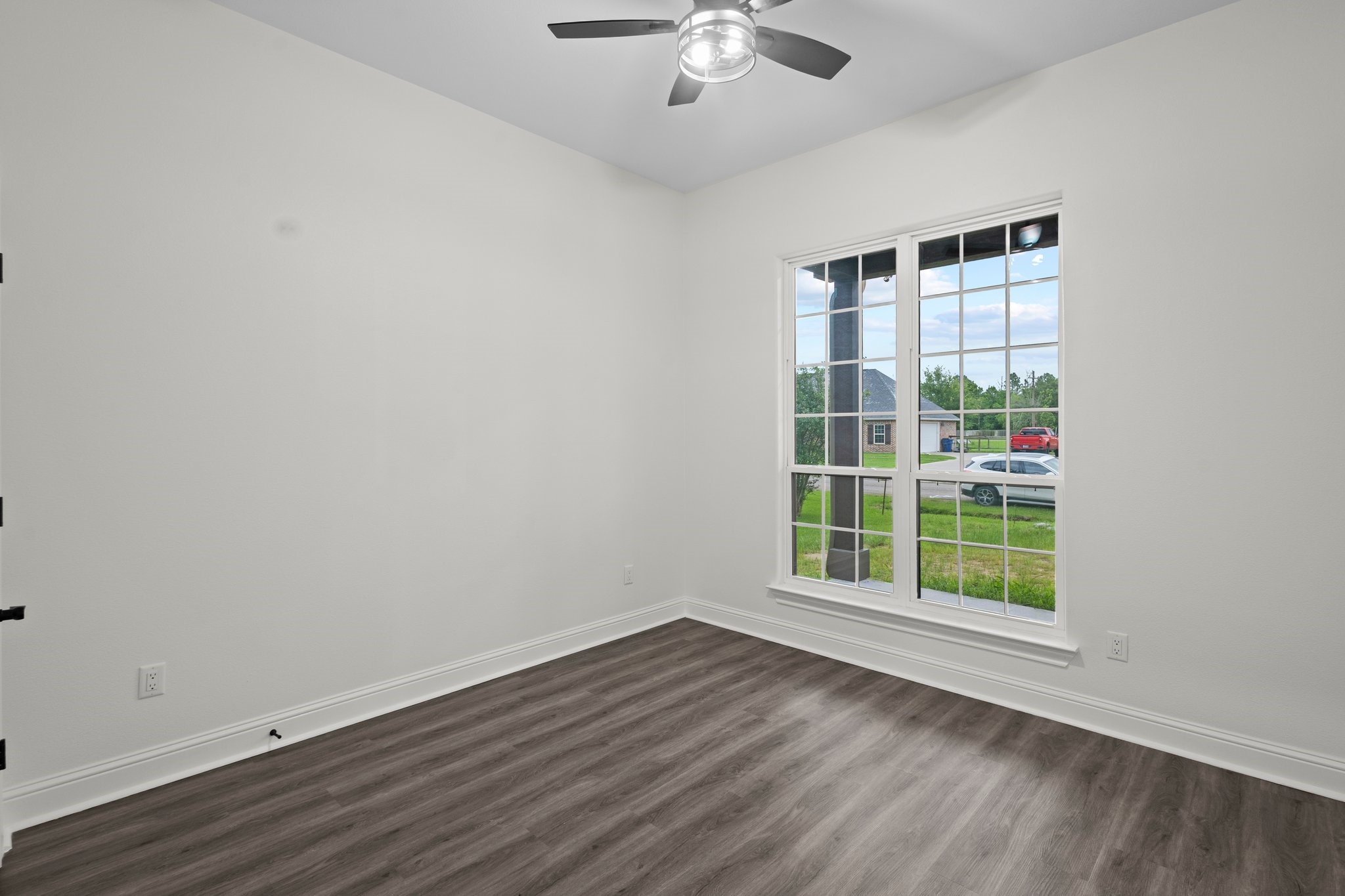 5250 HIghlander Drive Orange, TX 77630 - Photo 16 of 20 a view of an empty room with a window and wooden floor
