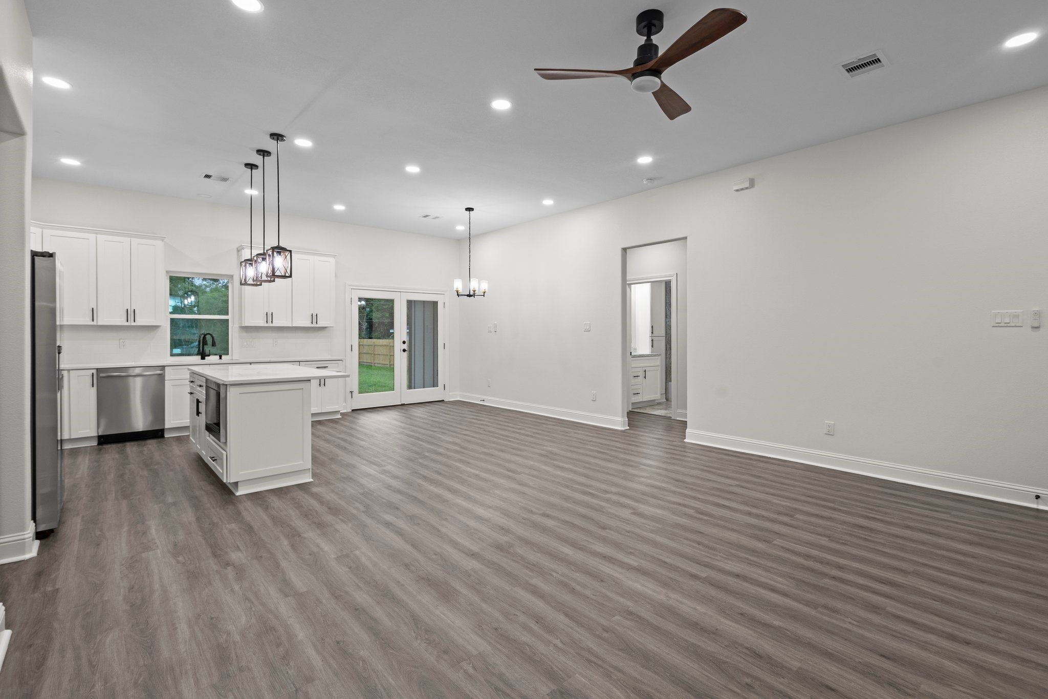 5250 HIghlander Drive Orange, TX 77630 - Photo 2 of 20 an open kitchen with kitchen island white cabinetry and refrigerator