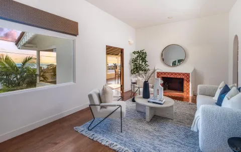 a living room with furniture a window and a fireplace