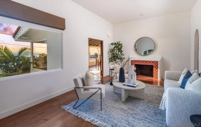 a living room with furniture a window and a fireplace