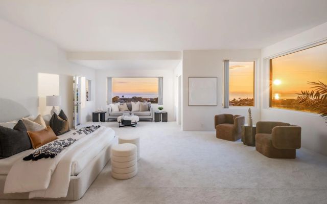 a living room with furniture fireplace and a large window