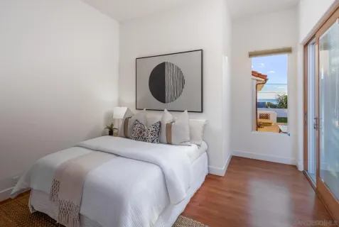 a bedroom with a bed and a mirror