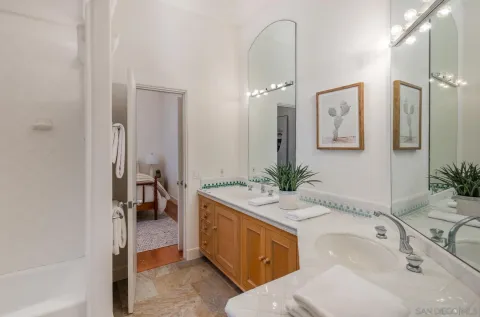 a spacious bathroom with a sink and a mirror
