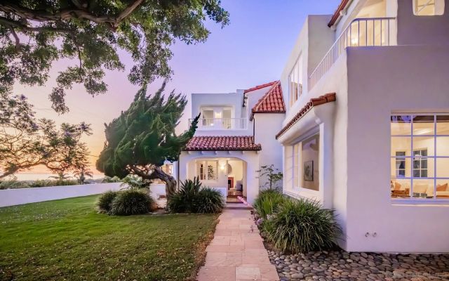 a front view of a house with garden