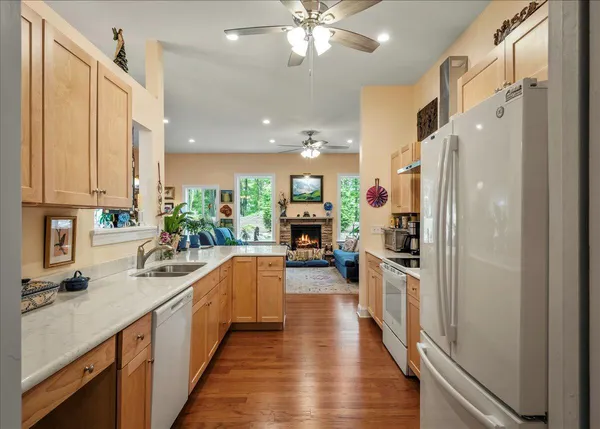 a kitchen with wooden floor and stainless steel appliances