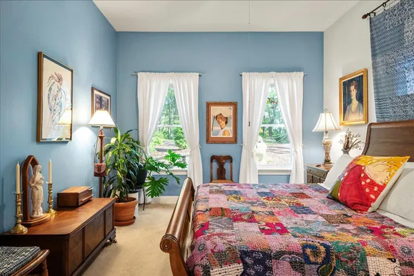 a bedroom with furniture and a potted plant