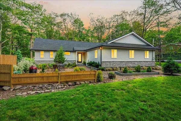 a front view of a house with garden