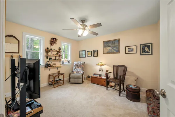 a view of a workspace with furniture and a window