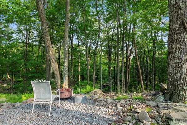 a view of yard with green space and seating area