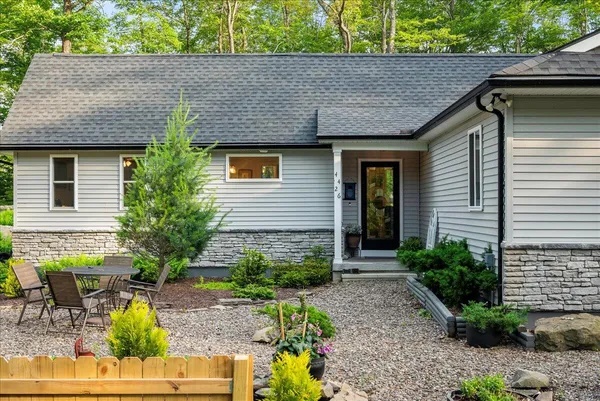 an aerial view of a houses with outdoor space and trees
