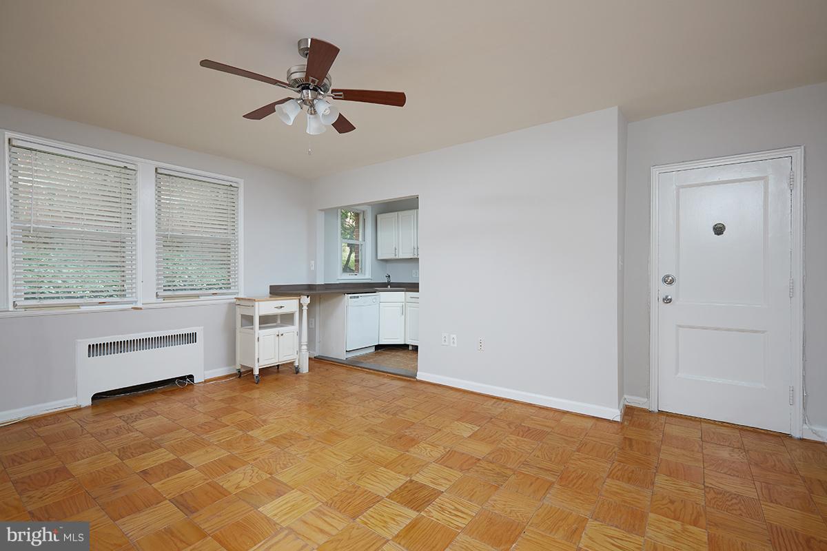 4004 Beecher Street Northwest, Unit 102 Washington, DC 20007 - Photo 4 of 24 a view of room with a ceiling fan and a window