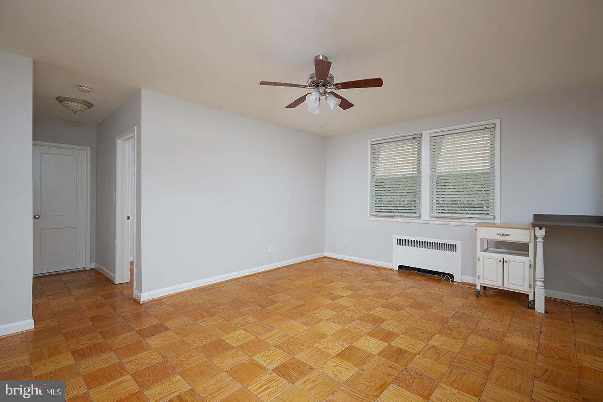 4004 Beecher Street Northwest, Unit 102 Washington, DC 20007 - Photo 5 of 24 a view of an empty room with a window