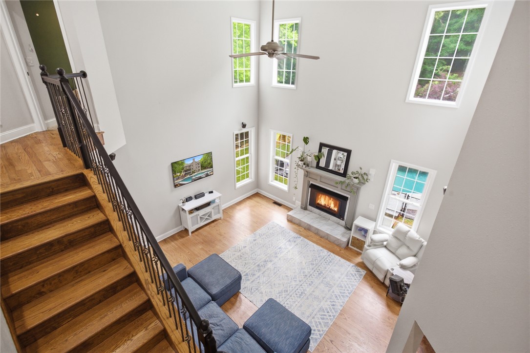 207 Devonhurst Drive Seneca, SC 29678 - Photo 17 of 50 This airy living space features soaring ceilings, a cozy fireplace, and rich hardwood floors.