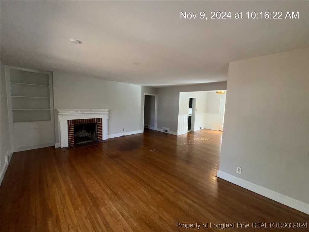 1429 Pine Valley Loop Fayetteville, NC 28305 - Photo 11 of 27 a view of an empty room with wooden floor fireplace and a window