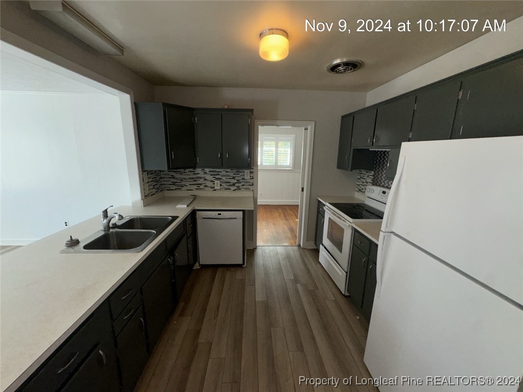1429 Pine Valley Loop Fayetteville, NC 28305 - Photo 13 of 27 a kitchen with a sink stove and refrigerator