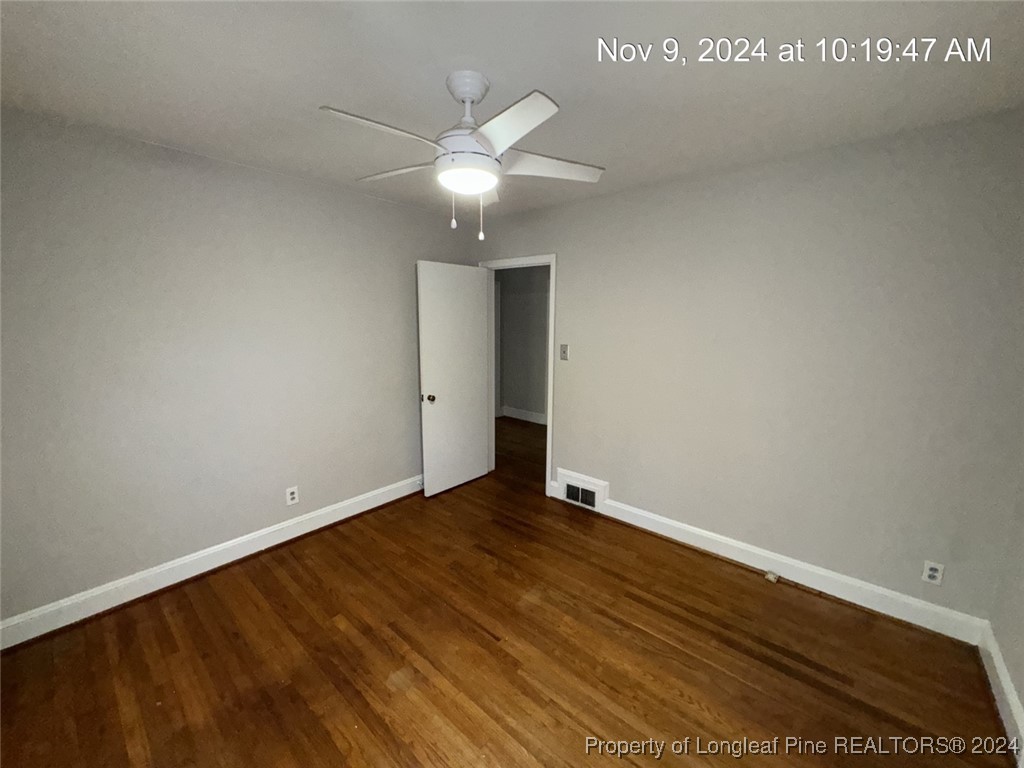 1429 Pine Valley Loop Fayetteville, NC 28305 - Photo 23 of 27 an empty room with wooden floor and fan