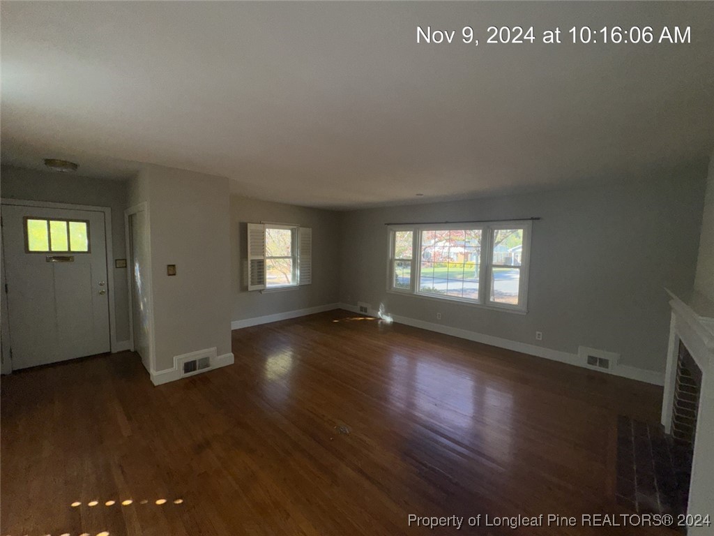1429 Pine Valley Loop Fayetteville, NC 28305 - Photo 9 of 27 an empty room with wooden floor and windows