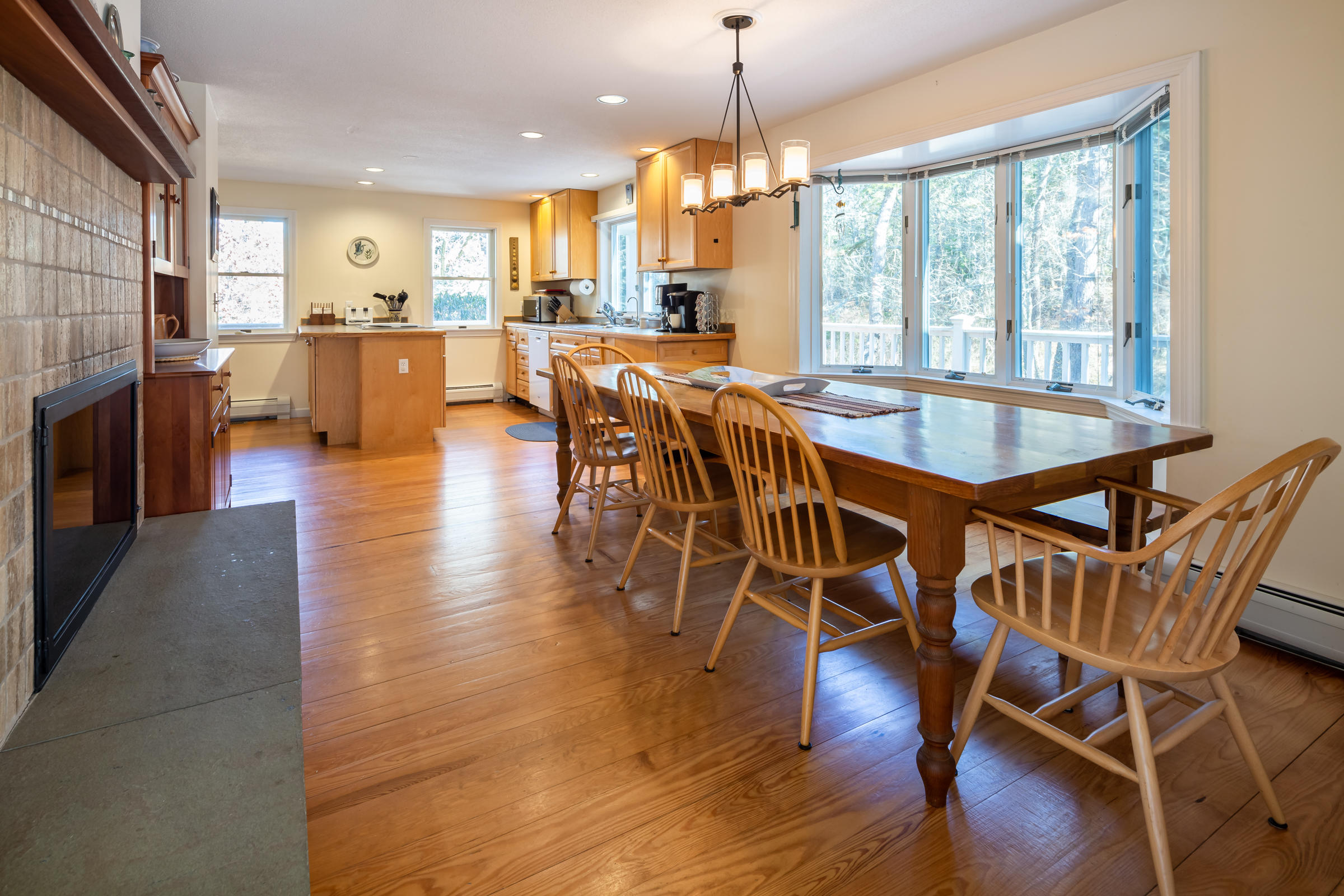 40 Chestnut Drive Orleans, MA 02653 - Photo 13 of 40 a view of a dining room and livingroom with furniture wooden floor a chandelier