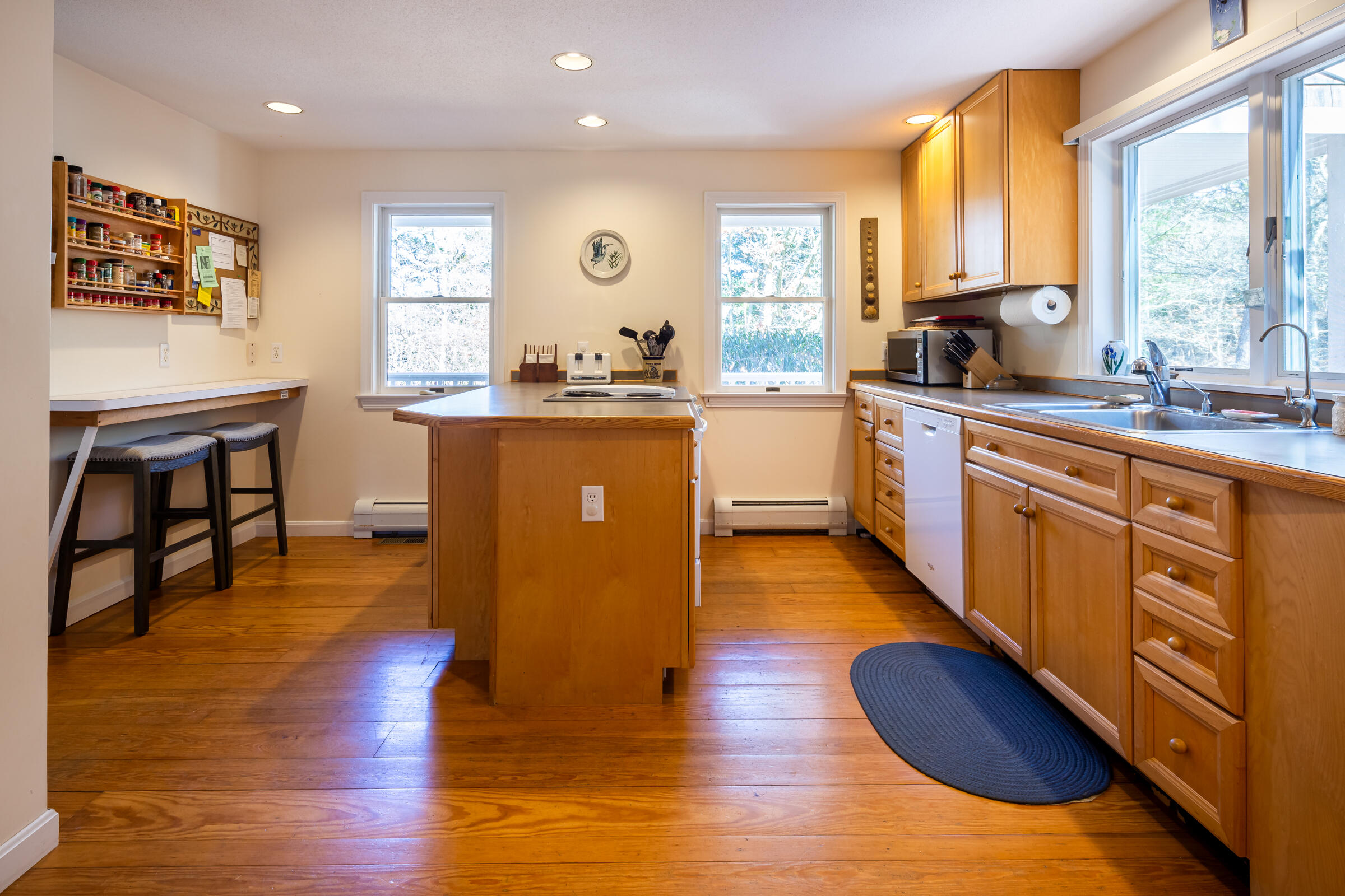 40 Chestnut Drive Orleans, MA 02653 - Photo 14 of 40 a kitchen with wooden floors and white walls
