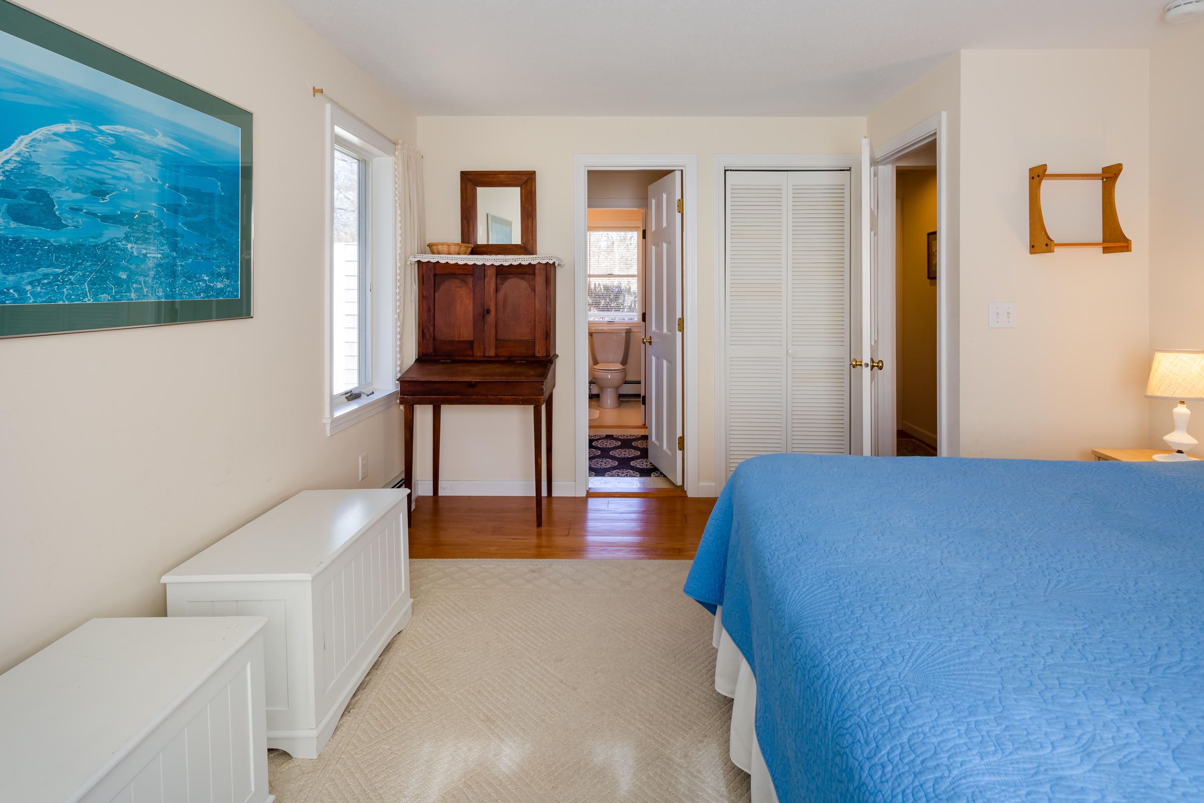 40 Chestnut Drive Orleans, MA 02653 - Photo 18 of 40 a bedroom with a bed and wooden floor