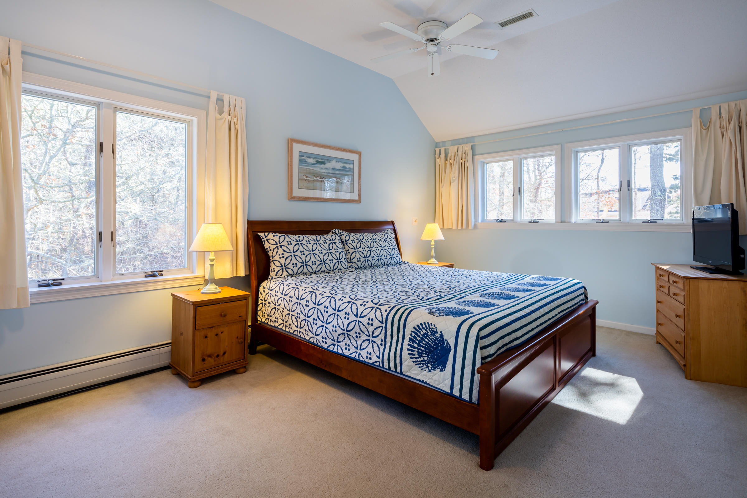 40 Chestnut Drive Orleans, MA 02653 - Photo 22 of 40 a bedroom with a bed and a dresser next to a window