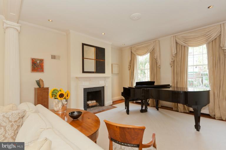a living room with furniture a fireplace and a table