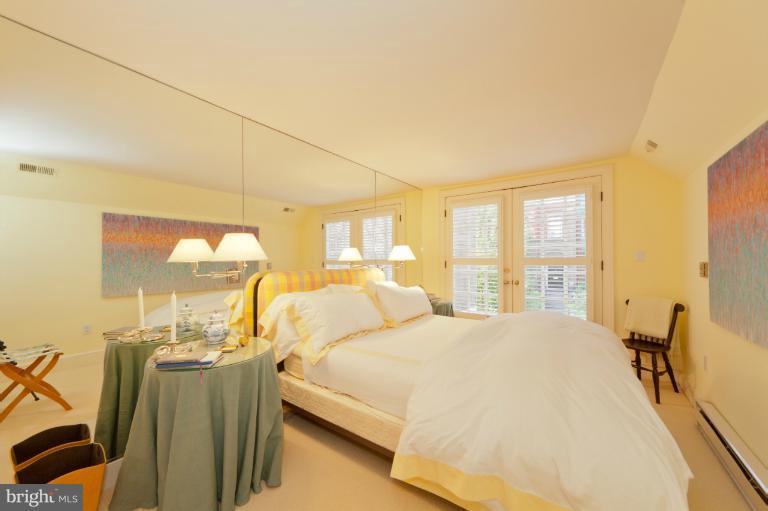 3122 N Street Northwest Washington, DC 20007 - Photo 17 of 19 a large bedroom with a bed and large windows