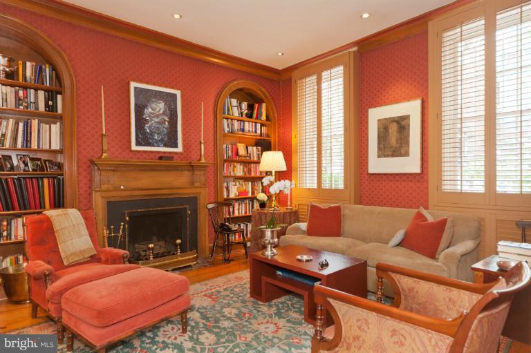 3122 N Street Northwest Washington, DC 20007 - Photo 8 of 19 a living room with furniture a bookshelf and a fireplace