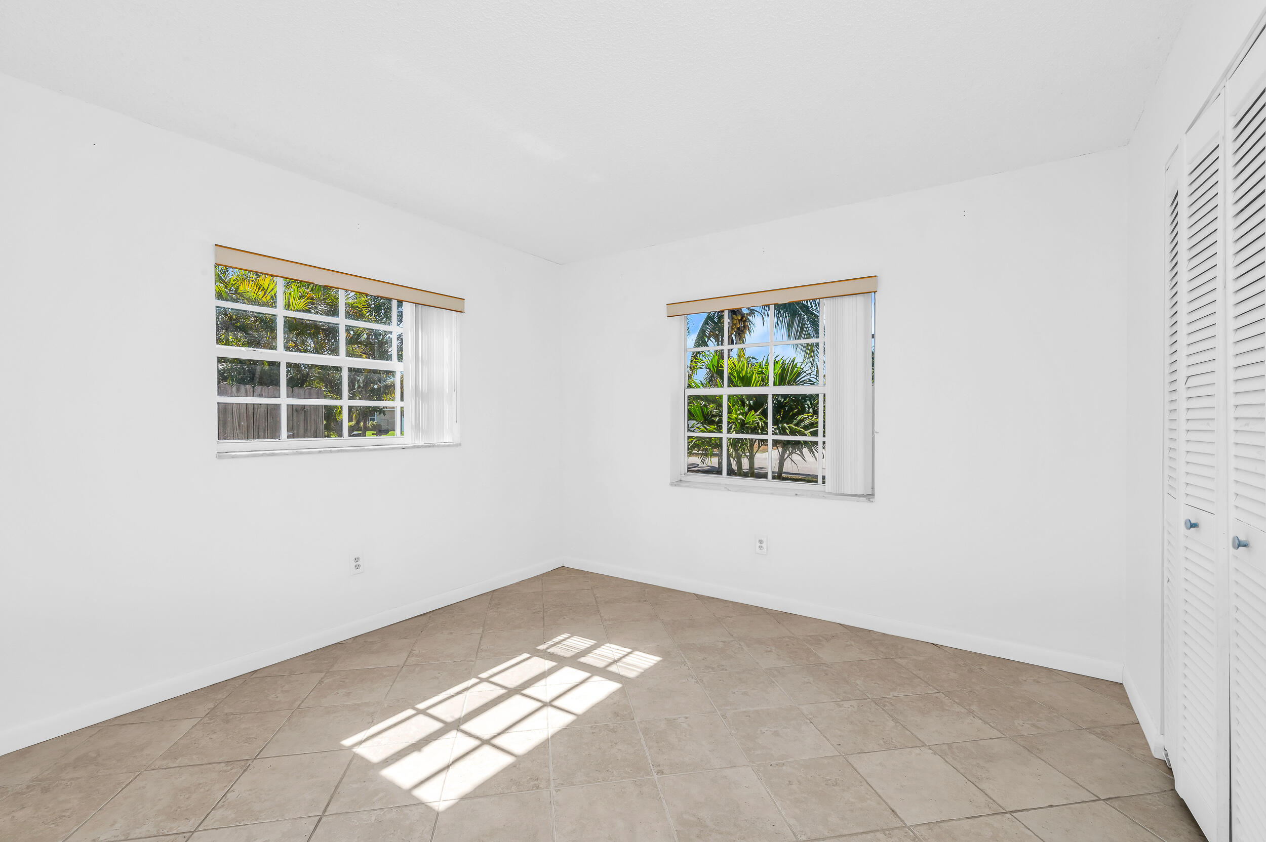 10905 Eureka Street Boca Raton, FL 33428 - Photo 16 of 16 an empty room with a window