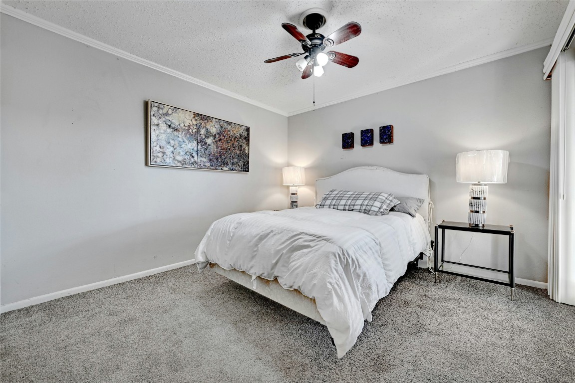1304 Summit Street, Unit 101 Austin, TX 78741 - Photo 8 of 13 a spacious bedroom with a bed and a chandelier