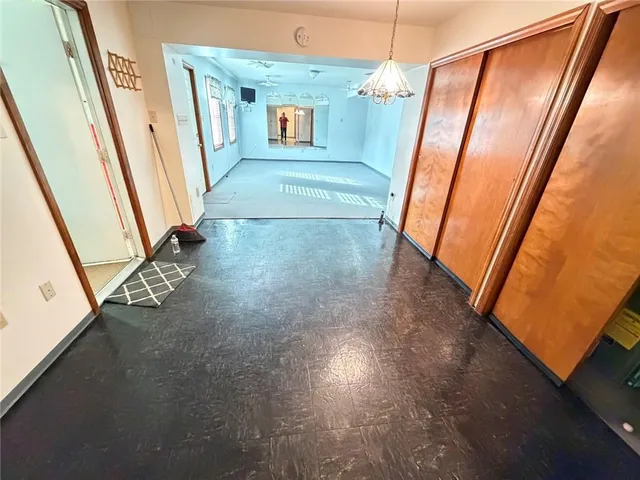 a view of a hallway with wooden floor and stairs