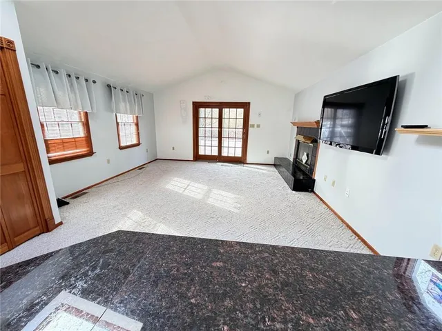 a view of a livingroom with furniture and a flat screen tv