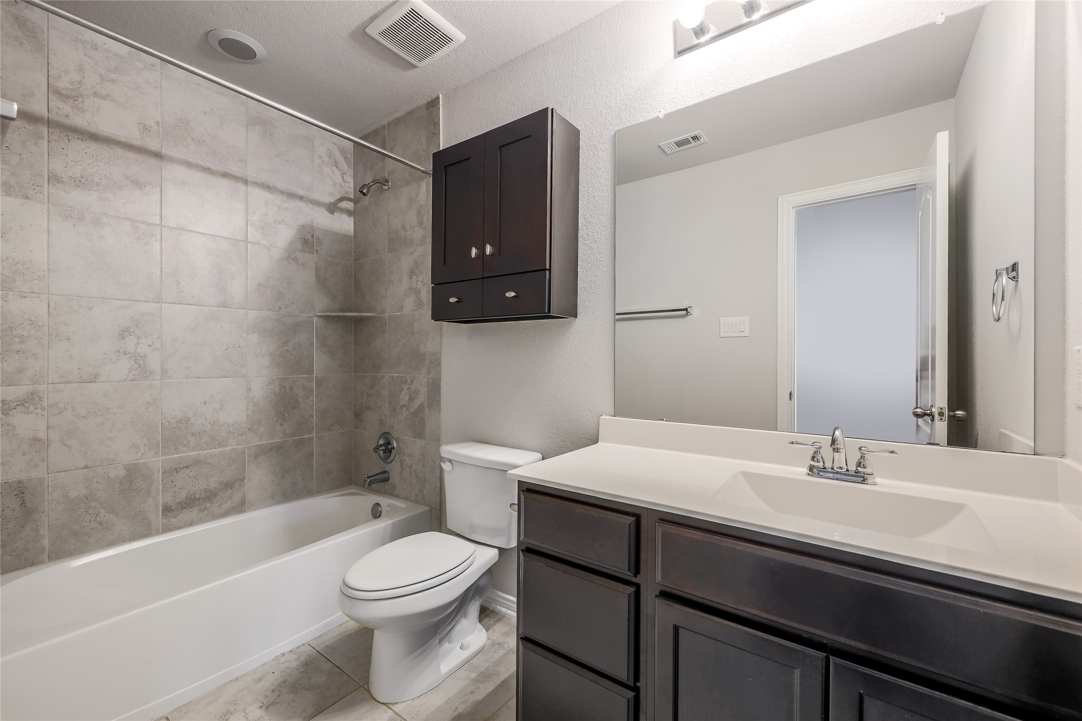 205 Penna Lane Georgetown, TX 78628 - Photo 25 of 32 A well-appointed bathroom offers a clean tub-shower combination, a floating cabinet, and an integrated sink vanity.