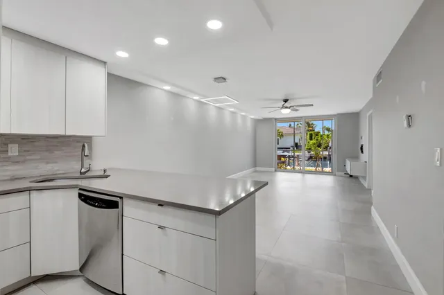 a kitchen with stainless steel appliances white cabinets and a sink