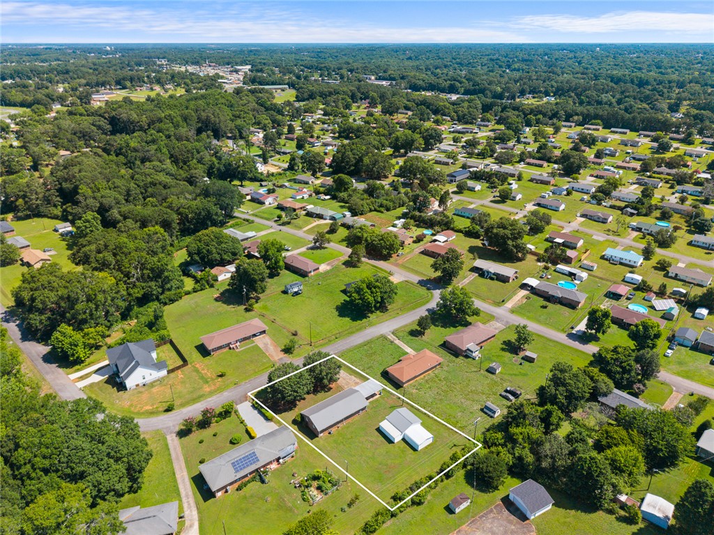 312 Edwards Drive Anderson, SC 29626 - Photo 40 of 44 An aerial perspective reveals a vast, tree-lined neighborhood with individual homes nestled among green landscapes.